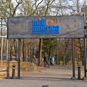 "Mid-America Science Museum" entrance sign over paved walking path