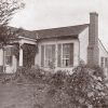 Single-story house with covered porch and brick chimney