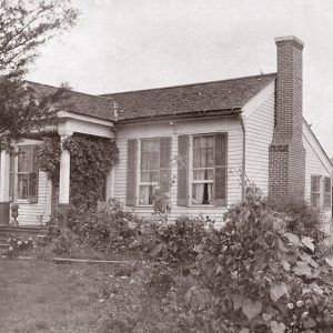 Single-story house with covered porch and brick chimney