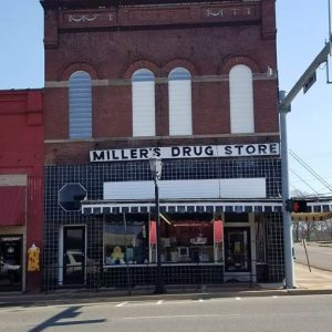 Two-story "Miller's Drug Store" on street corner