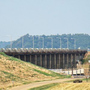 Concrete dam and highway bridge with street lamps