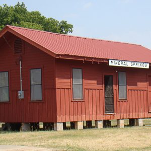 Red "Mineral Springs" depot building on cinder blocks