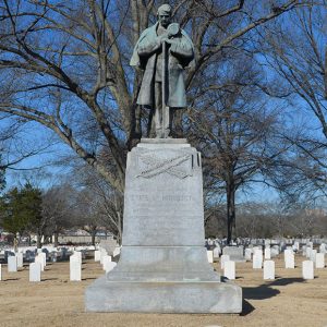 Statue of soldier standing on monument in cemetery