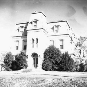 Multistory building with central tower and arched doorway