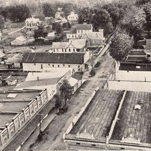 Multistory buildings and houses on town streets as seen from above