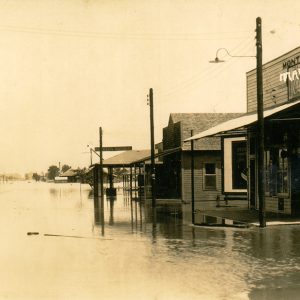 Storefronts and power lines on flooded streets