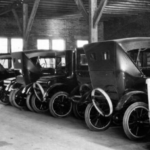 Line of cars parked inside a vehicle showroom