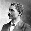 African-American man with mustache in suit and bow tie