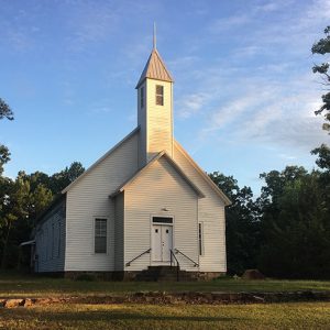 Front view of church building with steeple