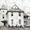 Five figures, perhaps children, outside multistory white wooden building with tower