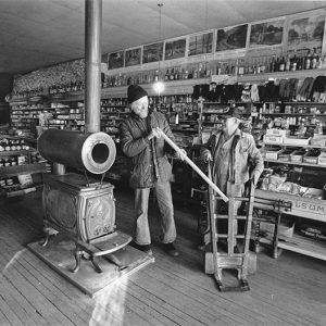 Pair of old white men in store with stove