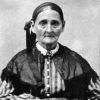 Old white woman in dress holding a book