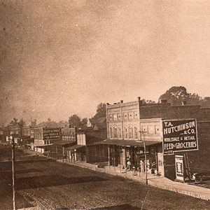 Multistory storefronts and town buildings on dirt roads