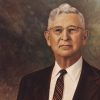 Older white man with glasses in suit and tie