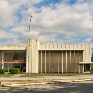 Multistory building with hanging glass windows on street