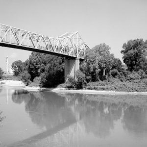 Steel truss bridge with concrete supports over river