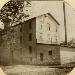 Multistory building with single-story brick extension with smoke stack