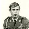 Young white man with blond hair in military uniform with medal