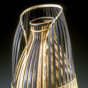 Ornamental straw basket with curved top and black strips