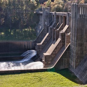 Water being released through concrete dam into spillway