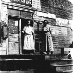 Two white women outside post office building