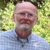 Older white man with glasses and beard in plaid shirt