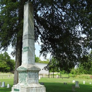 Spray painted obelisk monument in cemetery