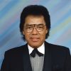 African-American man with glasses smiling in suit