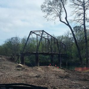 Steel truss bridge cleared grounds and river