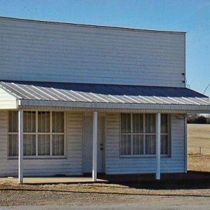 White single-story building with Coca-Cola sign