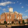 two story brick building with central tower