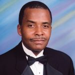 African-American man with mustache in tuxedo