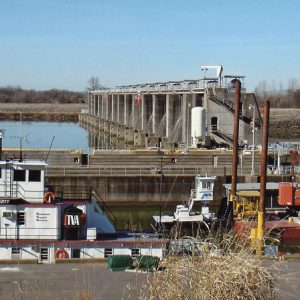 River with boat and machinery and concrete dam