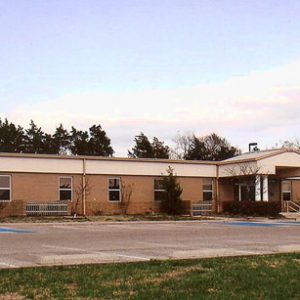 Single-story brick building with parking lot