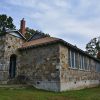 Stone building with arched entrance way and gabled roof