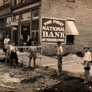 Men with picks and shovels in front of bank