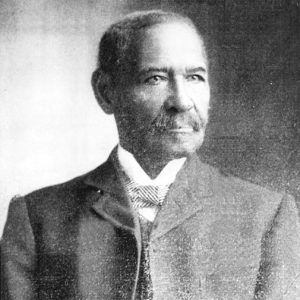 African-American man with a mustache in suit and tie