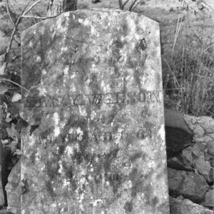 Close-up of weathered gravestone in cemetery