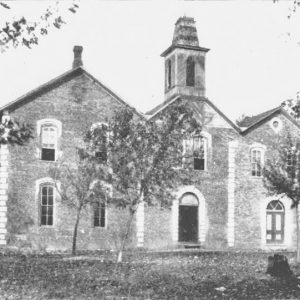 Two-story brick building with bell tower