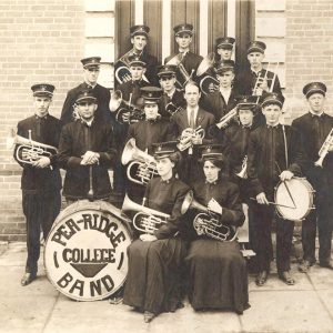 Group of young white men and women in uniforms with brass instruments and drums