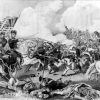 Men with weapons and flags in military uniforms charging each other amid clouds of smoke