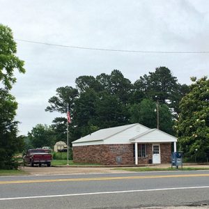 Single-story brick building with parking lot on street