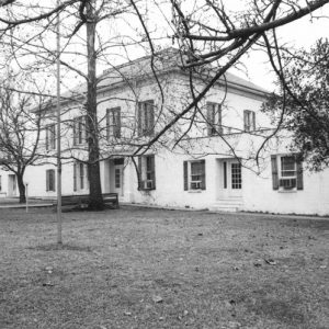 Two-story building with trees and grounds