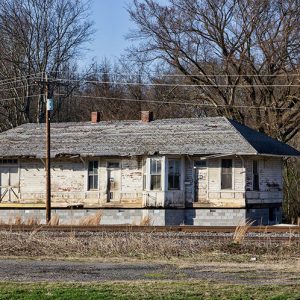 Abandoned train depot building with power lines