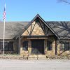 Single-story building with covered porch and stone walls