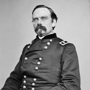 White man with mustache sitting in military uniform