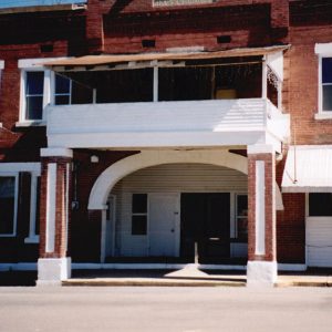 Close-up of multistory brick building with arched entrance