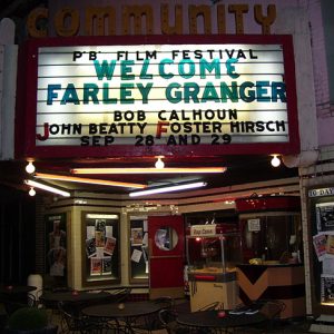 Theater building at night with "Welcome Farley Granger" on its marquee