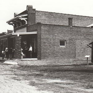 Brick building with people standing around in front