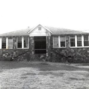 Stone building with twin staircases and paneled windows